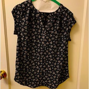 Small print, floral top. Cap sleeves long with curved hem.